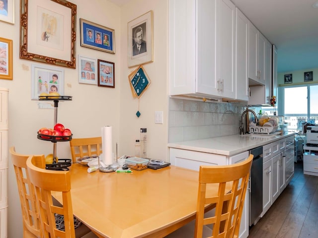 kitchen featuring sink, white cabinetry, and backsplash