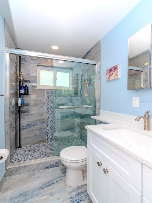 bathroom with vanity, toilet, and walk in shower