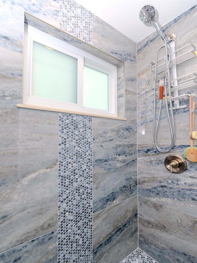 bathroom with a tile shower