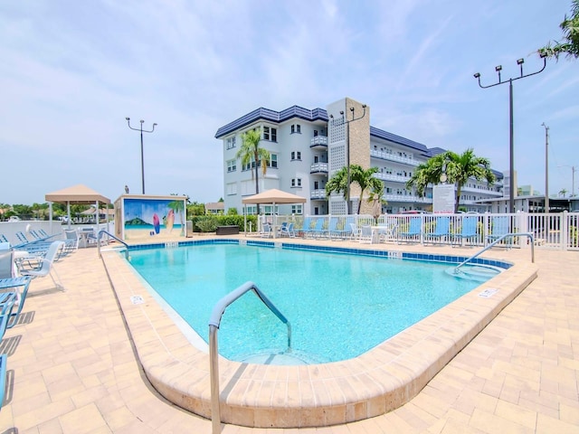 view of swimming pool with a gazebo and a patio