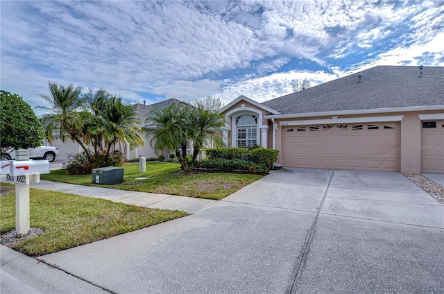 single story home with a front yard and a garage