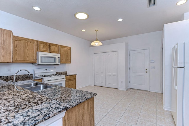 kitchen featuring decorative light fixtures, light tile patterned flooring, white appliances, and sink