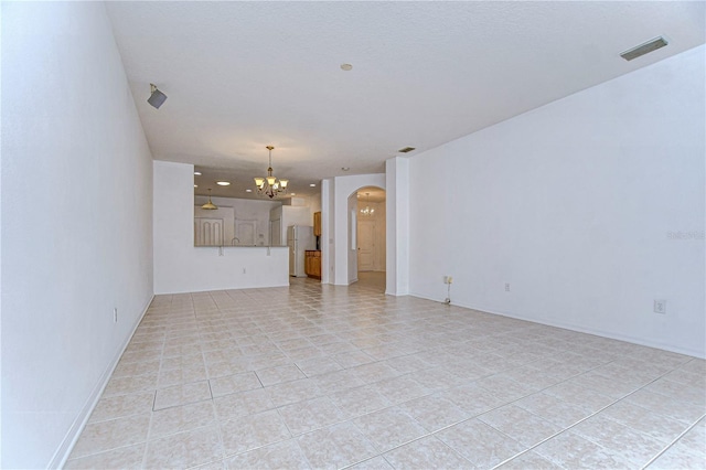 unfurnished living room with light tile patterned floors and a notable chandelier