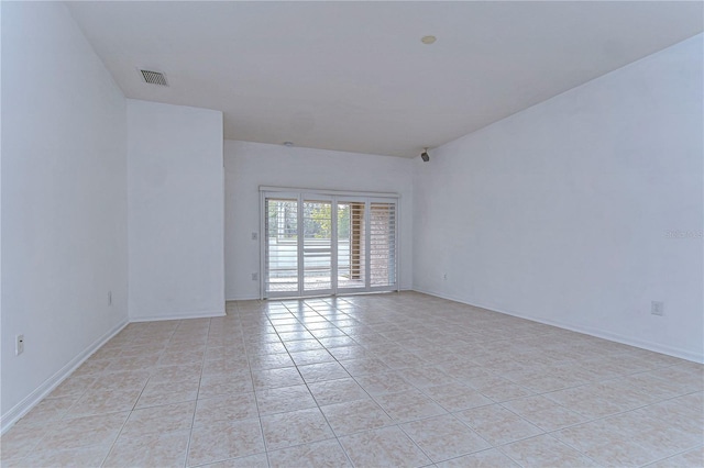 unfurnished room featuring light tile patterned floors