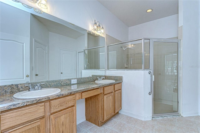 bathroom with tile patterned flooring, vanity, and an enclosed shower