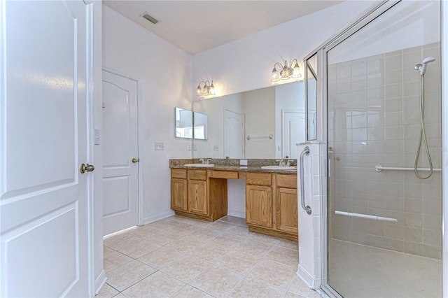 bathroom featuring tile patterned floors, vanity, and a shower with shower door