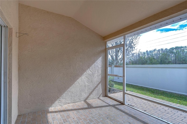 unfurnished sunroom with vaulted ceiling