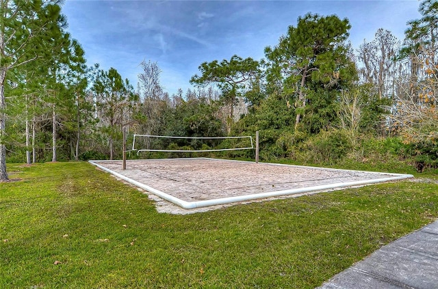 surrounding community featuring a lawn and volleyball court