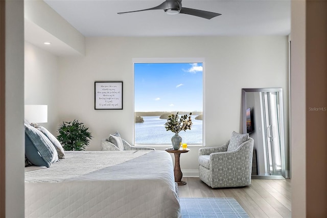 bedroom with light wood-type flooring and ceiling fan