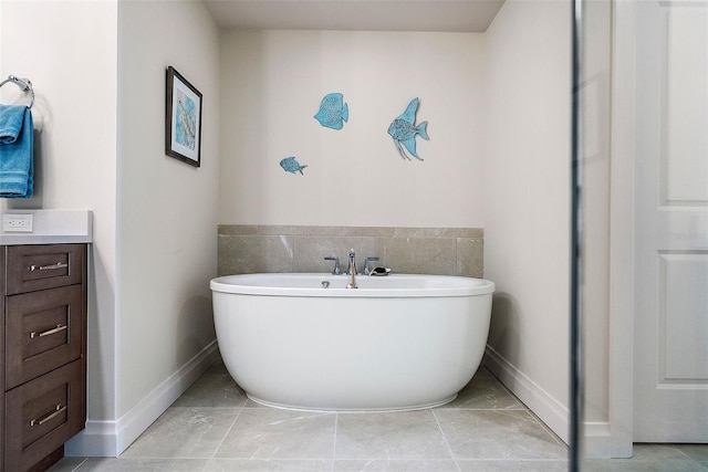 bathroom featuring a washtub and vanity