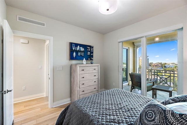 bedroom featuring access to exterior and hardwood / wood-style flooring