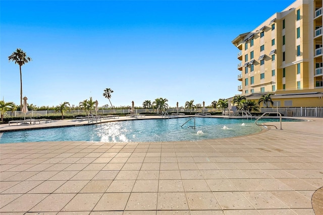 view of pool featuring pool water feature and a patio area