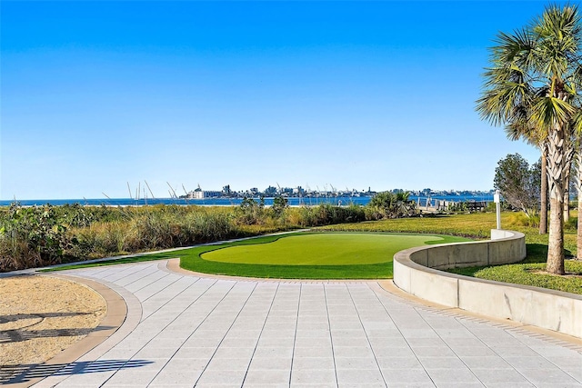 view of property's community featuring a water view and a lawn