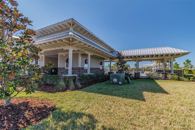 view of property exterior featuring ceiling fan and a lawn