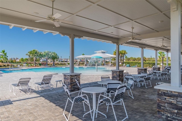 view of patio / terrace featuring a community pool and ceiling fan