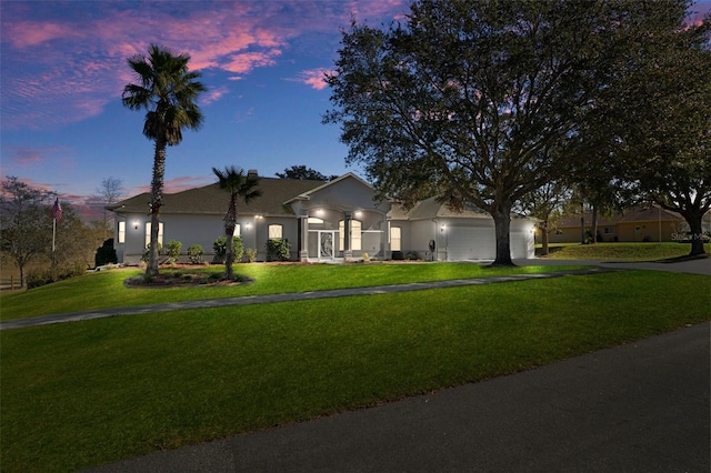 view of front of house featuring a lawn and a garage