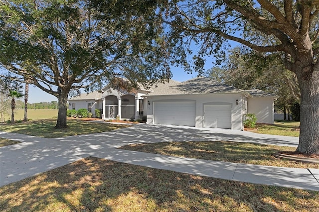 ranch-style home featuring a garage and a front lawn