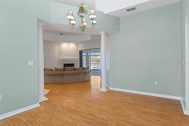 unfurnished living room with light hardwood / wood-style floors and an inviting chandelier