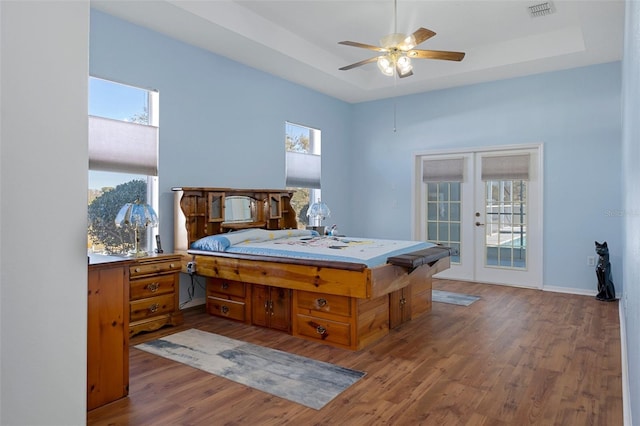 bedroom with access to outside, ceiling fan, french doors, and hardwood / wood-style flooring