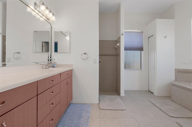 bathroom with tile patterned flooring, vanity, and shower with separate bathtub