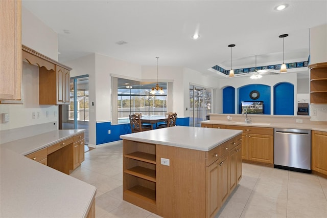 kitchen featuring pendant lighting, dishwasher, a center island, sink, and light tile patterned floors