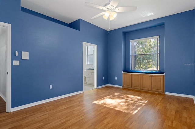 unfurnished room featuring ceiling fan and hardwood / wood-style flooring