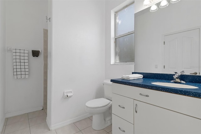 bathroom featuring tile patterned flooring, vanity, and toilet