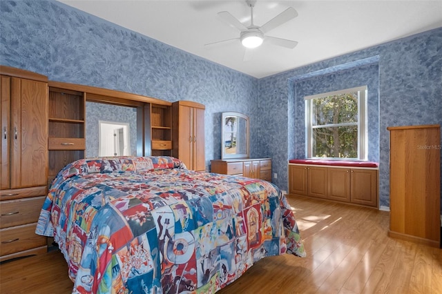 bedroom with light hardwood / wood-style floors and ceiling fan