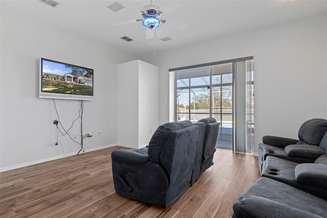 living room with ceiling fan and wood-type flooring