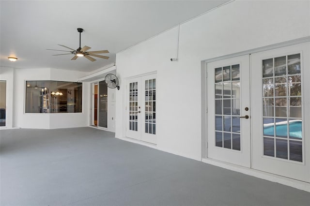 interior space with ceiling fan and french doors