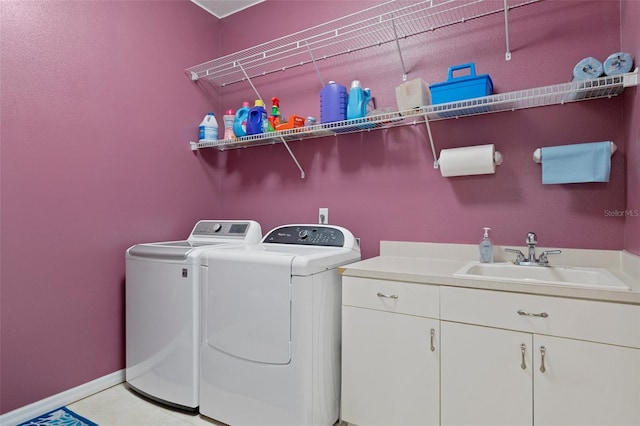 laundry room featuring washer and clothes dryer, light tile patterned flooring, cabinets, and sink