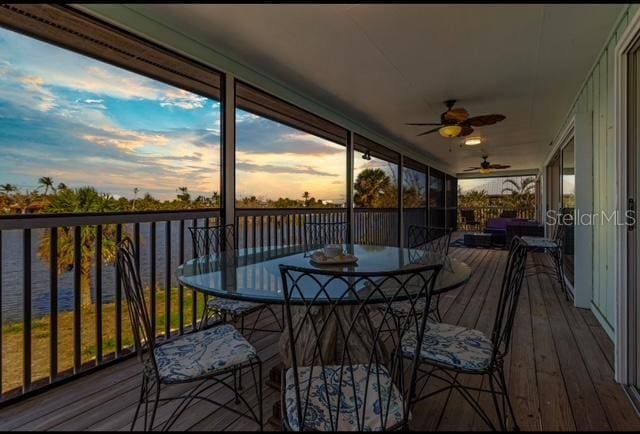 465 Lake Murex Cir, Sanibel, FL 33957 - deck at dusk featuring a water view and ceiling fan