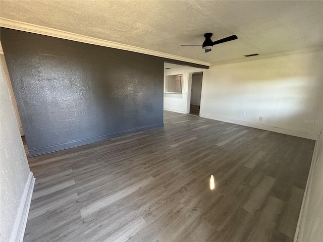 unfurnished room featuring ceiling fan, a textured ceiling, dark hardwood / wood-style floors, and ornamental molding