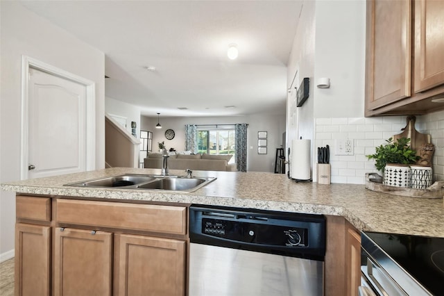 kitchen with kitchen peninsula, decorative backsplash, dishwasher, and sink