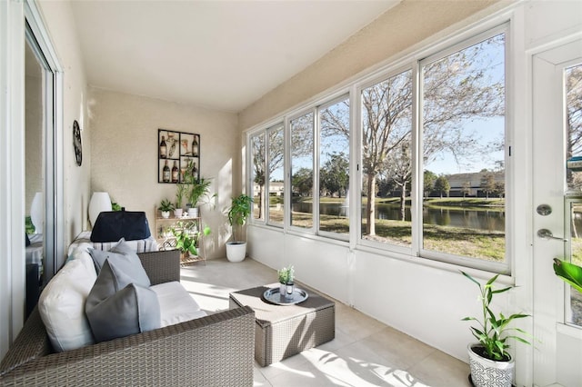 sunroom / solarium featuring a water view