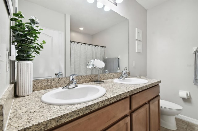 bathroom featuring tile patterned flooring, vanity, and toilet