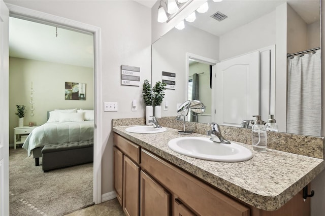 bathroom with tile patterned floors and vanity