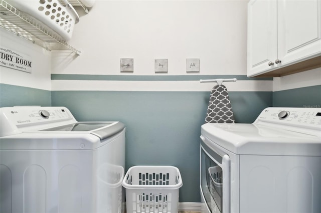 laundry area featuring cabinets and washing machine and dryer