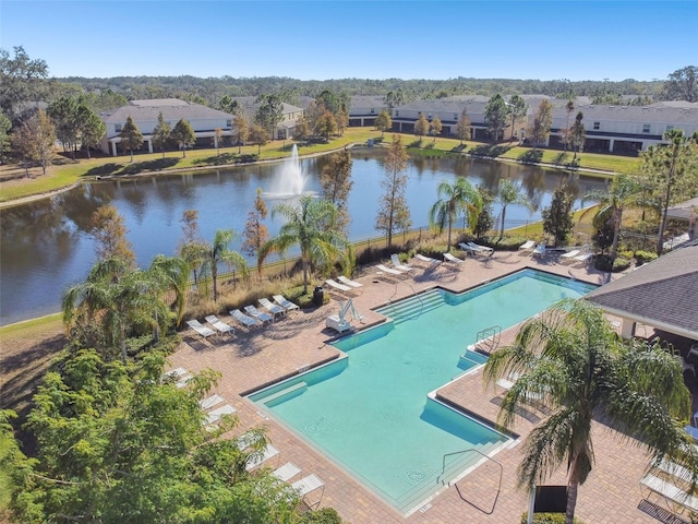 view of swimming pool featuring a water view and a patio area