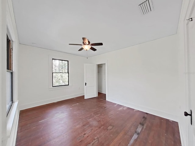 unfurnished bedroom with dark hardwood / wood-style flooring and ceiling fan