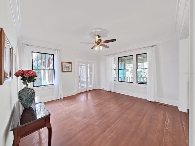 interior space with french doors, ceiling fan, ornamental molding, and hardwood / wood-style floors