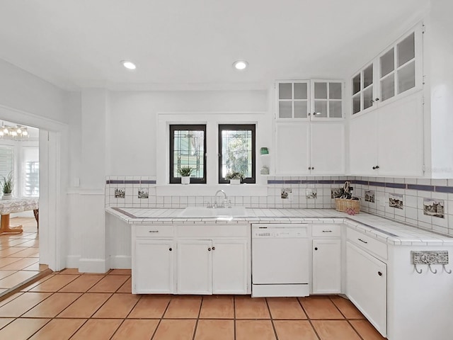 kitchen featuring tile countertops, white cabinets, dishwasher, and light tile patterned floors