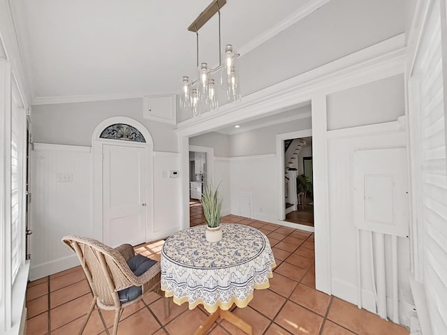 dining room with light tile patterned floors and crown molding