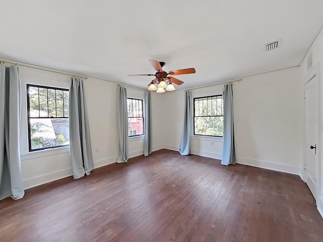 empty room featuring dark hardwood / wood-style flooring and ceiling fan