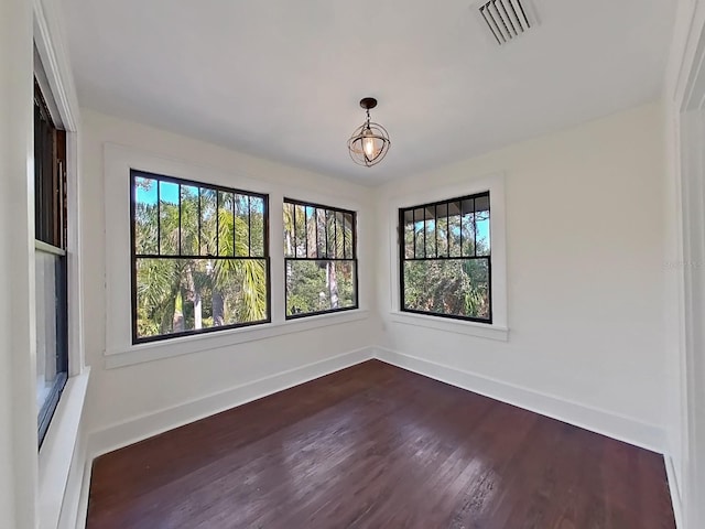 empty room featuring dark hardwood / wood-style floors and plenty of natural light