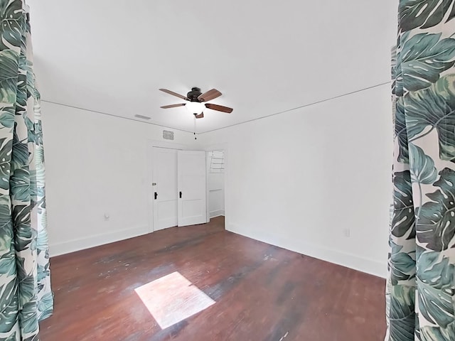 unfurnished room featuring ceiling fan and dark hardwood / wood-style floors