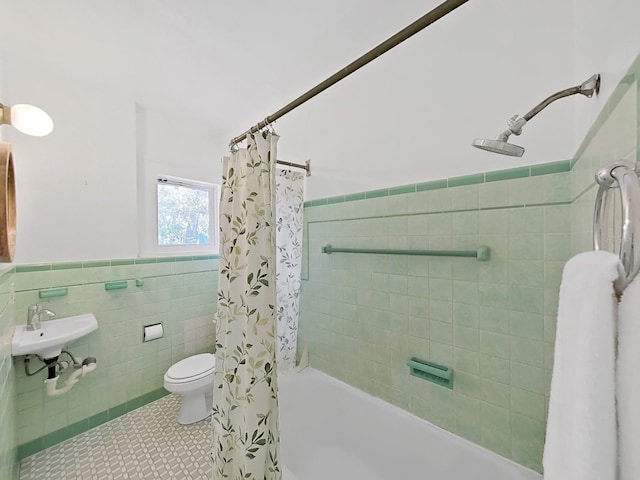 full bathroom with tile walls, tile patterned flooring, shower / tub combo, and sink