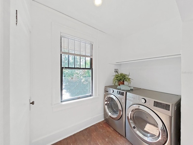 clothes washing area with hardwood / wood-style floors and independent washer and dryer