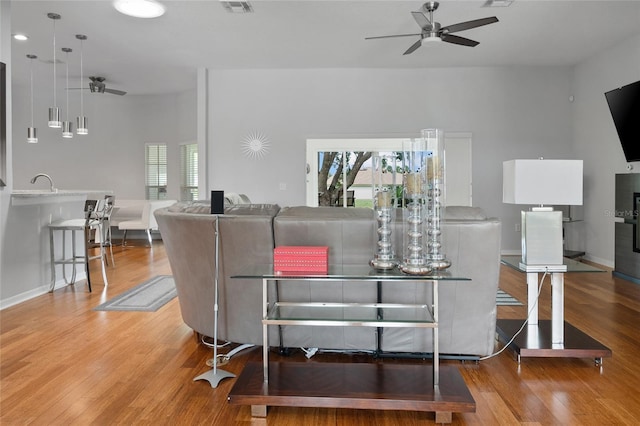 living room featuring hardwood / wood-style floors, ceiling fan, and a healthy amount of sunlight