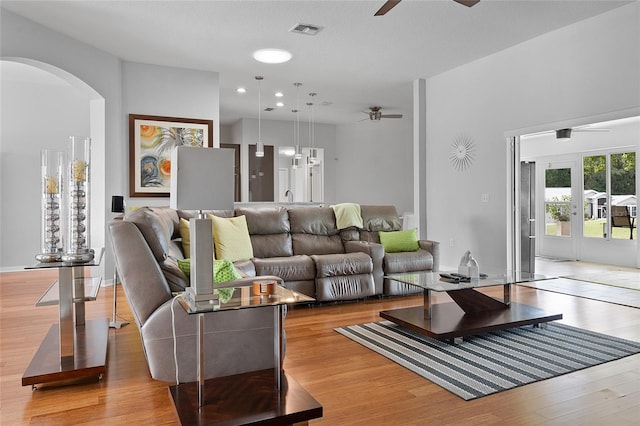 living room with french doors and light hardwood / wood-style flooring